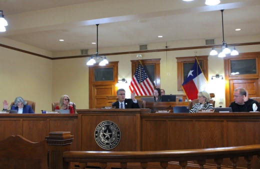 Three judges raise their hands in favor of a motion to add a new district court.