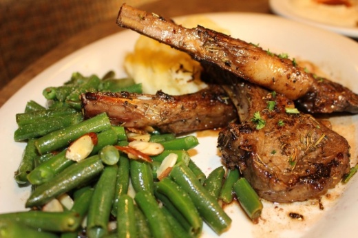 Red Oak Grill's lamb chop plate ($31.99) comes with lamb marinated in red wine, served with almond green beans and mashed potatoes. (Asia Armour/Community Impact)