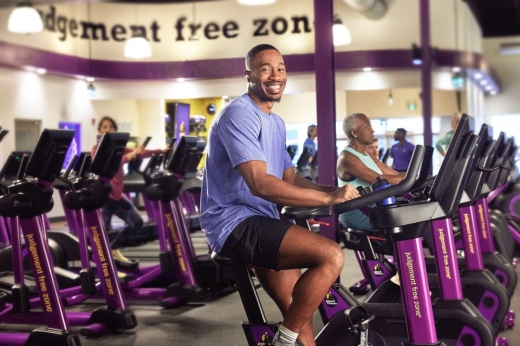 Man riding a stationary bike at Planet Fitness