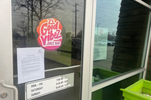 Business logo and signs posted on glass door and windows