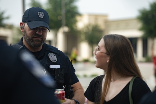 A police officer talking to a teenage girl