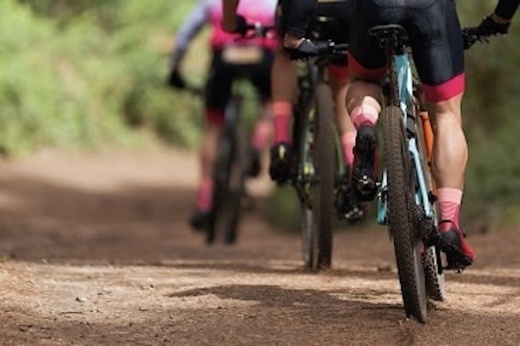 a group of people riding bikes on a trail