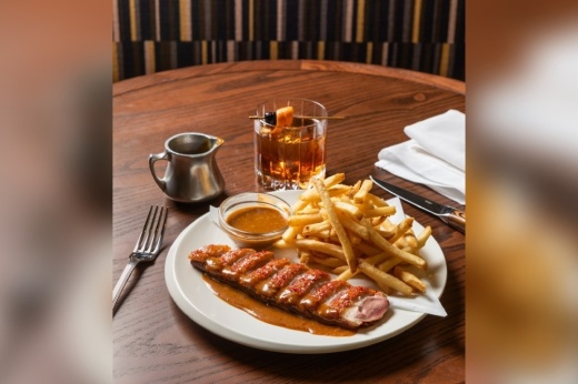 Duck frites from Perseid, served with mango, french fries and sauce au poivre verts. (Courtesy Perseid via Instagram)