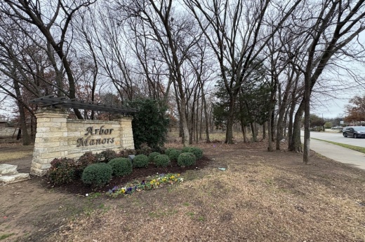 Image of the 2-acre site purchased by Peak Development Partners pictured with the Arbor Manors residential sign in the foreground.