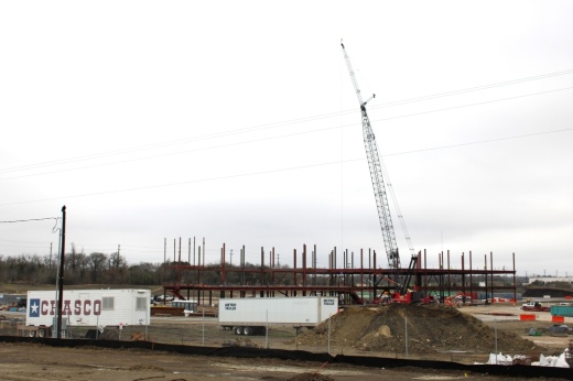 A crane looms over a construction project for a future headquarters building.
