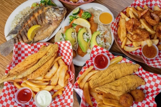 Various fried and grilled fish plates from an overhead perspective.