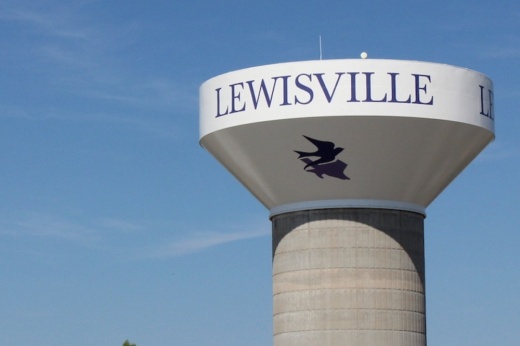 Image of Lewisville water tower with the city logo pictured on the side.