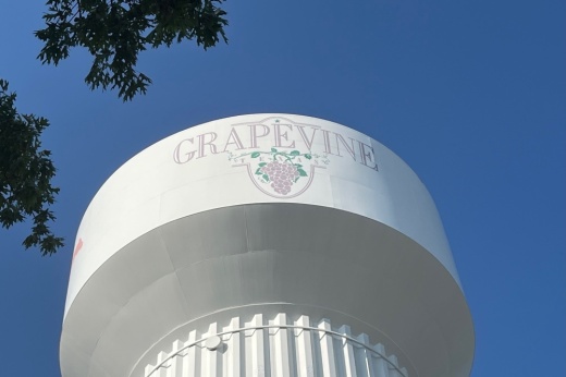 Image of Grapevine water tower with logo pictured on the side.