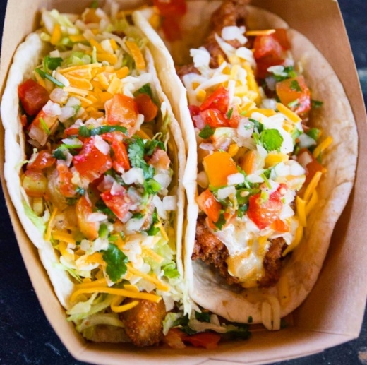 Two tacos in a cardboard container.