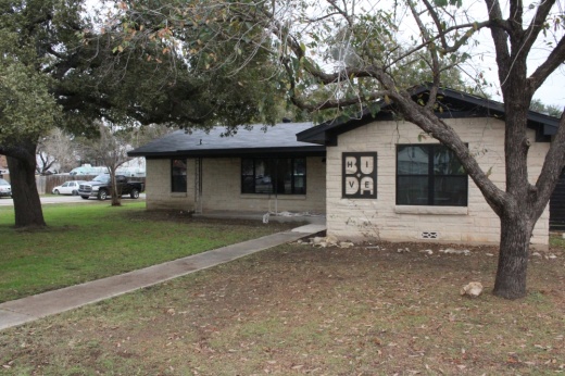 A house that has a sign that says Buda HIVE on it