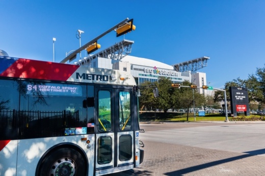 A photo of a METRO bus stopped at a light.