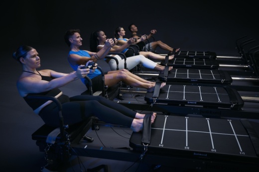 People working out against a dark backgroun