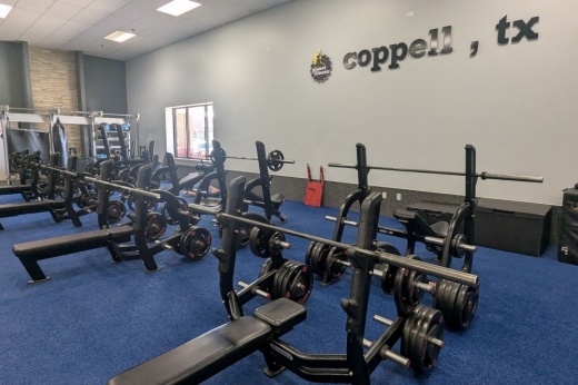 Several bench press stations sit within the gym area of Planet Fitness in Coppell.