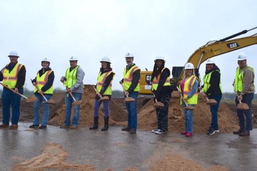 City officials hold shovels of dirt at the groundbreaking ceremony.