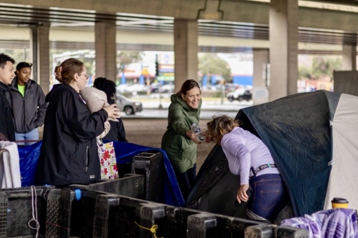 Sallie Alcorn, an at-large Houston City Council member, hands out water to a homeless individual Jan. 30 during the Coalition for the Homeless of Houston/Harris County’s 2025 Point-in-Time Count and Survey. (Courtesy Coalition for the Homeless of Houston/Harris County)