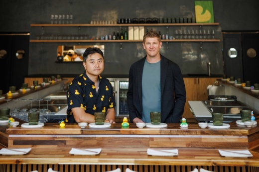 Two men at a sushi bar