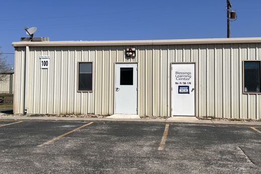 A photo of a building that has a door that says Blessings Learning Center