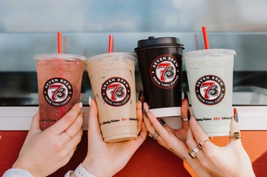 people hold up four coffee cups in a photo