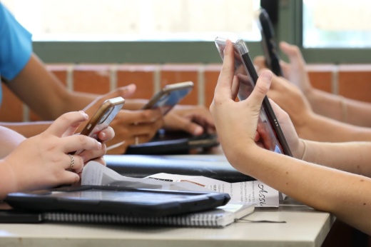 Students using cell phones and tablets.
