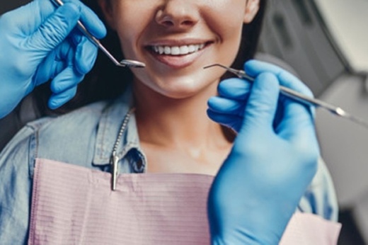 A patient receiving a teeth cleaning in a dentist's office.