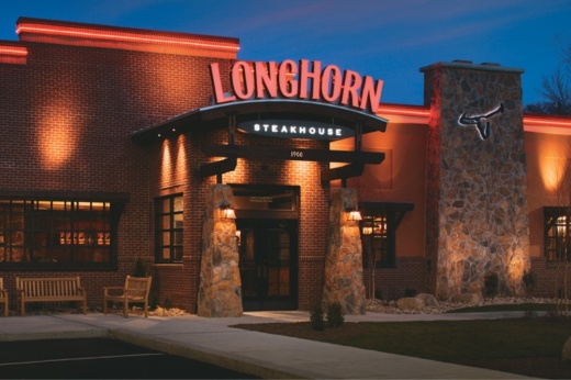 The exterior of a LongHorn Steakhouse is shown at dusk.