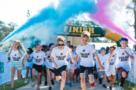 People run through colorful clouds
