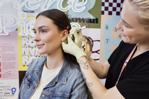 girl getting ears pierced