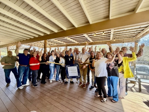 A group of people at a ribbon cutting.