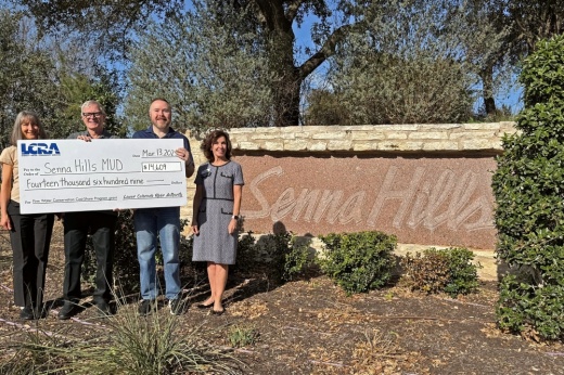 LCRA representatives present a $14,609 grant to the Senna Hills Municipal Utility District for monitors to help locate leaks within its water distribution system. From left: Stacy Pandey, LCRA senior water conservation coordinator; Chet Palesko, Senna Hills MUD president; Chris Kite, Utilimatics chief technology officer; and Carol Freeman, LCRA Board member. (Courtesy Lower Colorado River Authority)