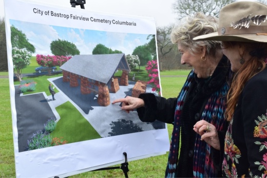 Community members look at a rendering of the columbarium during the groundbreaking ceremony.