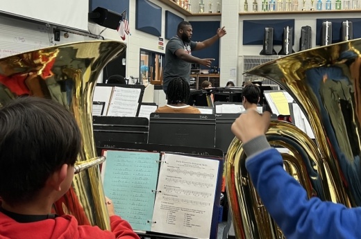 Bryson Clegg, associate director of bands at Haggard Middle School, leads students during rehearsal. (Community Impact staff)