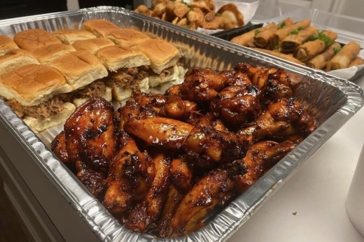 Chicken wings and pulled pork sliders on a tray