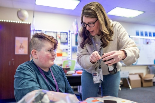student working with teacher