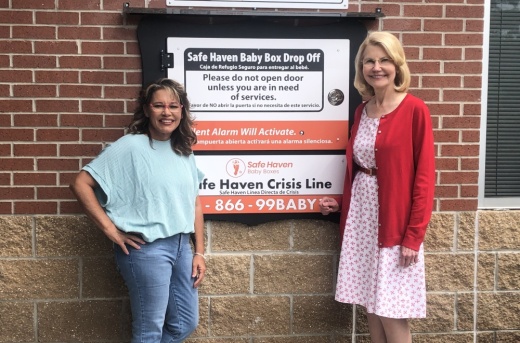 women posing with a Safe Haven box