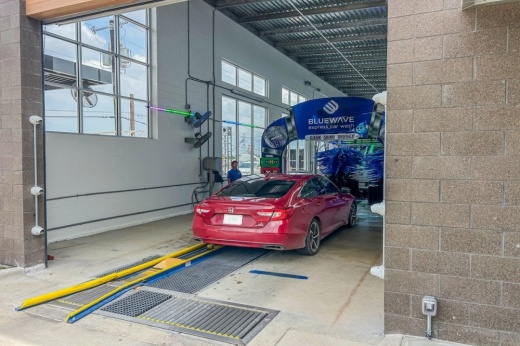 A red car goes through a car wash in Schertz, Texas.