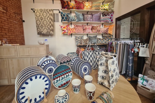 Table and shelves of bags and other decor for sale