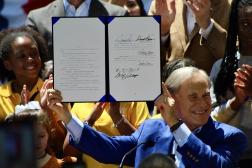 Gov. Greg Abbott smiles after signing Senate Bill 2, which will create a state-run education savings account program, during a May 3 event at the governor's mansion in Austin. (Hannah Norton/Community Impact)