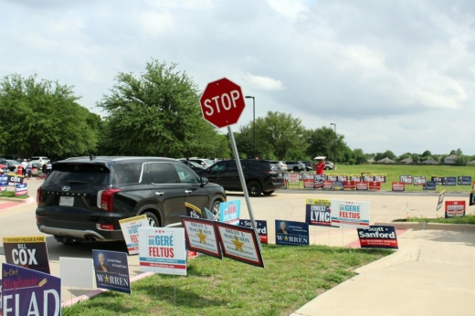 election signs, a car and a stop sign at gay library