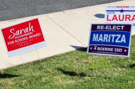 Sarah Faulkenberry and Maritza Gonzalez-Cooper signs