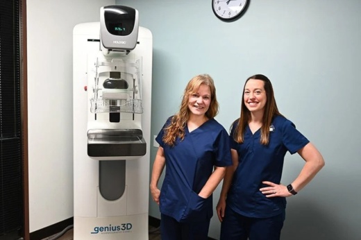 An image of two employees with a medical machine.