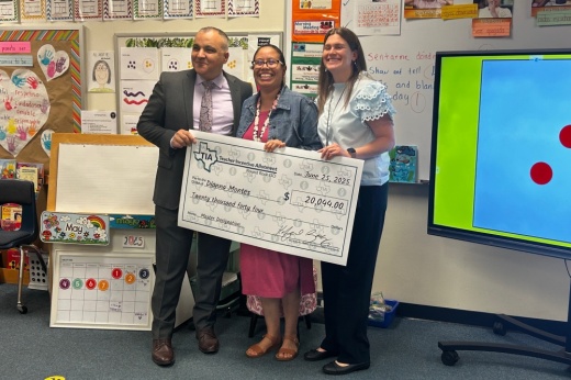 Superintendent Hafedh Azaiez (left) and Berkman Elementary School Principal April Nilson (right) present an incentive check to teacher Dianna Montes (center). (Brooke Sjoberg/Community Impact)