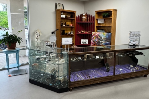 Interior of a retail store including a glass jewelry case .