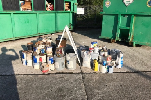 Cans of paint near recycling bins