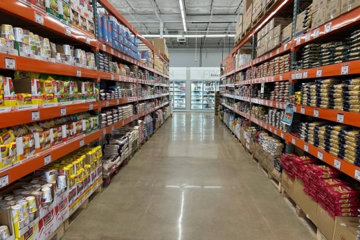 Long shot of grocery store shelves facing each other on an aisle.