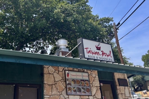 An exterior shot of a building that has a sign that says Taiwan Bowl