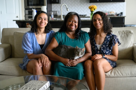 With support from Arrow Child & Family Ministries, Allanda Nichols (center) and Christopher Jones (not pictured) adopted twins Malaina (left) and Alaina Jones (right) in November 2020 after the girls spent almost 10 years in the foster care system. (Jamaal Ellis/Community Impact)
