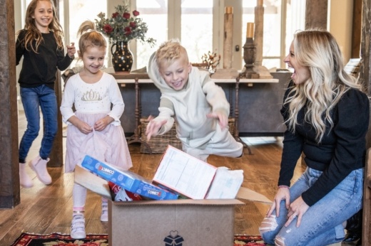 Kids jumping toward box full of items