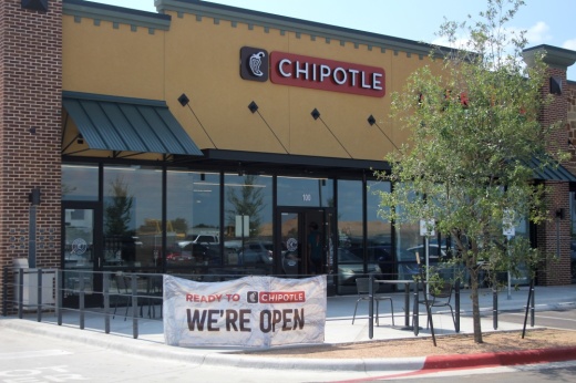 The exterior is shown with a "we're open' sign out front.