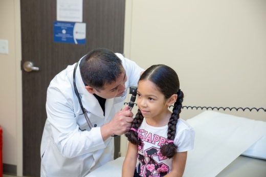 Physician Jonathan Santos treats a patient at Lone Star Family Health Center. This spring, the nonprofit completed an expansion that included additional medical exam rooms. (Courtesy Lone Star Family Health Center)