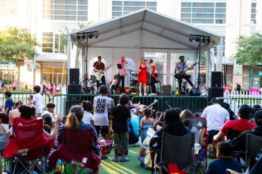 crowd listens to live band perform